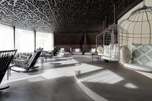 a living room with chairs and a ceiling with patterns at SILENA, your soulful hotel - adults only in Valles