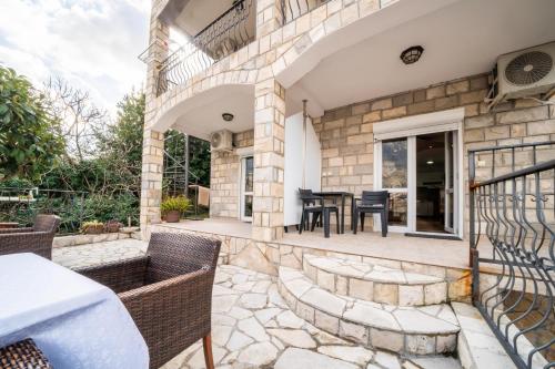 an outdoor patio with a table and chairs at Apartments Vuković in Kotor