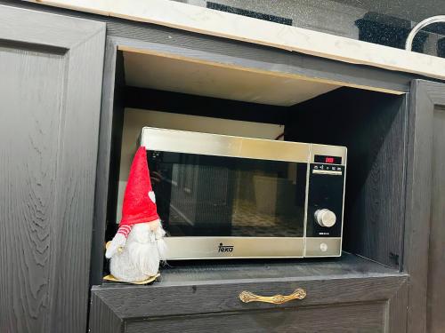 a santa hat is sitting in a microwave at D Le Roi Soleil Premium Suites in Hanoi
