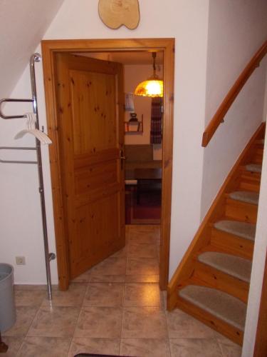 a hallway with a door and stairs in a house at Finnhäuser am Vogelpark - Haus Andrea in Marlow