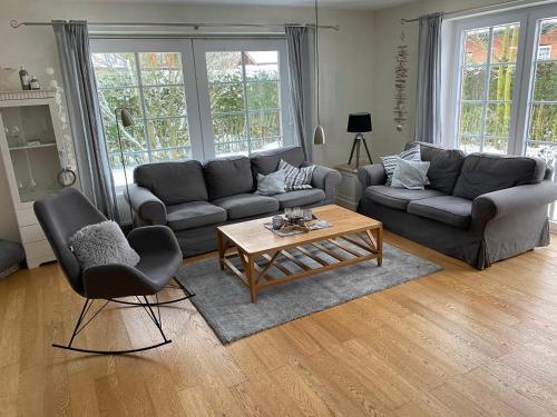 a living room with a couch and a coffee table at Nordwind in Oevenum