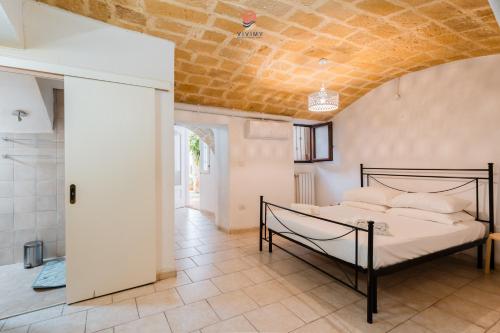 a bedroom with a bed in a room at Dimora Cantalupi by Vivimy in Gallipoli