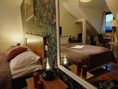 a bedroom with a bed with a mirror and red candles at Willa Pod Basztą Restauracja&Wellness in Kazimierz Dolny