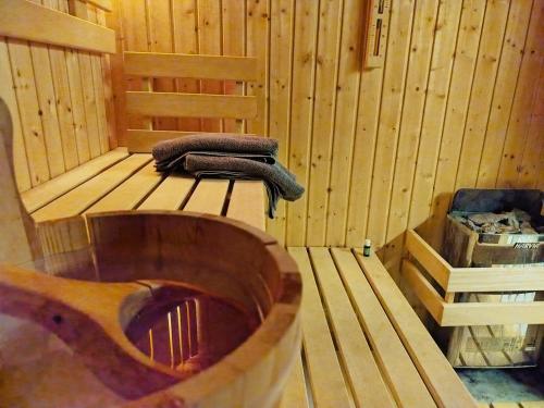 a wooden sauna with a wooden tub and a towel at Willa Pod Basztą Restauracja&Wellness in Kazimierz Dolny