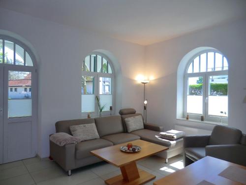 a living room with a couch and a table at Leuchtturm - Whg1 in Wyk auf Föhr