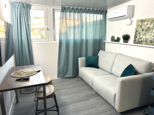 a living room with a couch and a table at Topdown Apartments in Hospitalet de Llobregat
