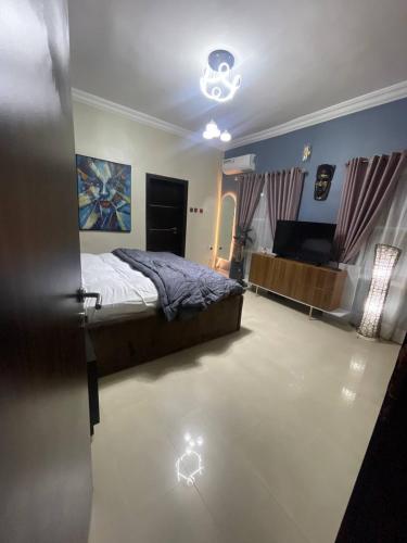 a bedroom with a bed and a light on the floor at 2 BEDROOM HOME AWAY FROM HOME WITH - 1 BEDROOM Option in Sagisa