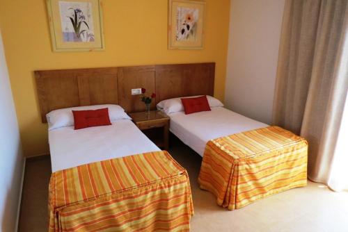 トレ・デル・マールにあるApartamentos Turisticos Las Yucasのホテルルーム ベッド2台付