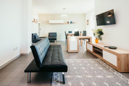 a living room with a couch and a table at Bigattera Apartments in Varese