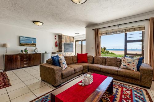 a living room with a couch and a table at Ocean Dream Beach Cottage in Swakopmund