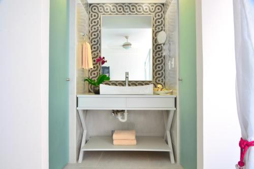 a bathroom with a sink and a mirror at Unic Design Hotel & Restaurant- 5th Avenue in Playa del Carmen