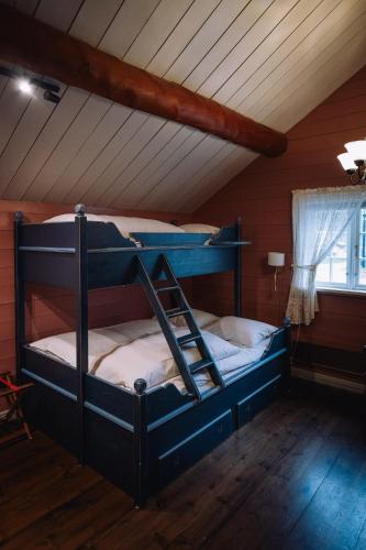 a bedroom with a bunk bed in a attic at Byrkjedalstunet Hotell in Byrkjedal
