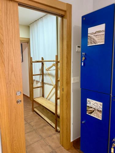 a room with a staircase and a blue door at B&B Puente de Órbigo in Hospital de Órbigo