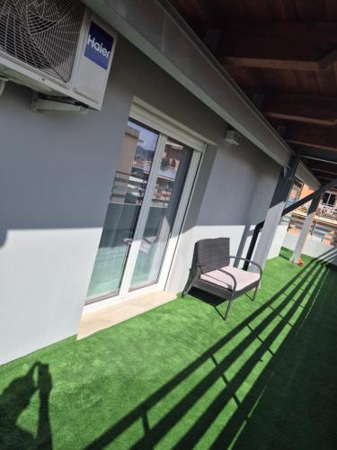 a shadow of a chair sitting on a patio at Attico Solaris in Reggio Calabria