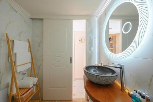 a bathroom with a bowl sink and a mirror at Villa Helena Santorini- Private Plunge Pool & BBQ in Mesaria