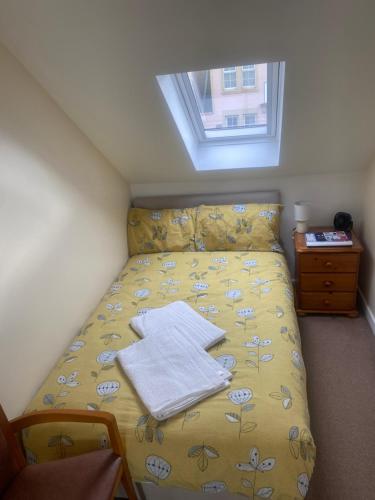 a bedroom with a bed with towels on it at 30 College Street, Buckhaven, Leven, Fife, KY81JX in Buckhaven