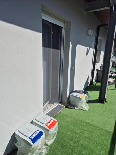 two frisbees sitting on the grass next to a door at Attico Solaris in Reggio Calabria