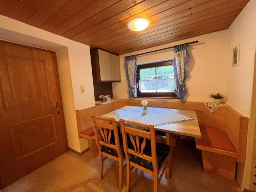 a kitchen with a wooden table and chairs and a window at Chalet Hannelore-3 by Interhome in Sölden