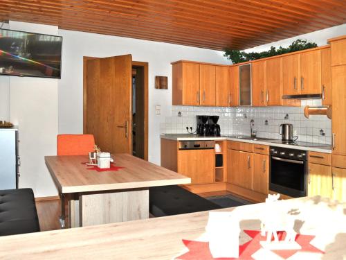 a kitchen with wooden cabinets and a wooden table at Apartment Miramonte-3 by Interhome in Kappl