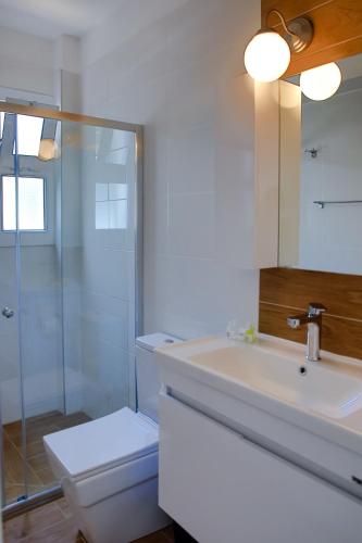 a bathroom with a sink and a toilet and a shower at Ground Garden View Apartments in Caesar Resort & SPA, Long Beach in Perivolia tou Trikomou