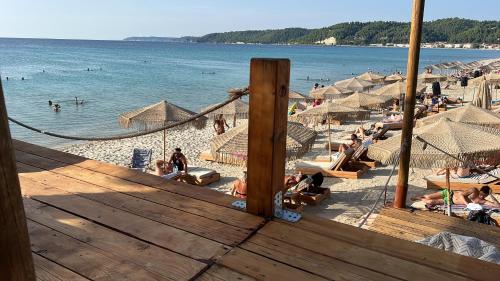 a beach with a bunch of people in the water at Peaceful modern holiday vila in Skála Foúrkas
