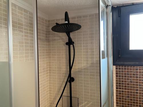 a shower with a shower head in a bathroom at Peaceful modern holiday vila in Skála Foúrkas