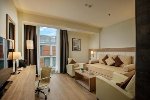 a hotel room with a bed and a desk at DoubleTree By Hilton Milan in Milan