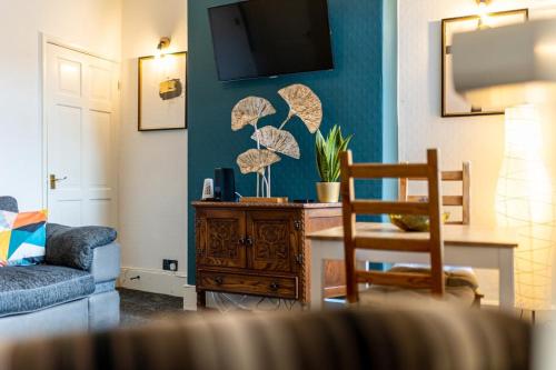 a living room with a couch and a table at 3 Bedrooms & 2 Showers - Home From Home in Newcastle under Lyme