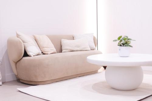 a living room with a couch and a table at Sauna - Massage - Double Shower - Luxe in Romans in Romans-sur-Isère