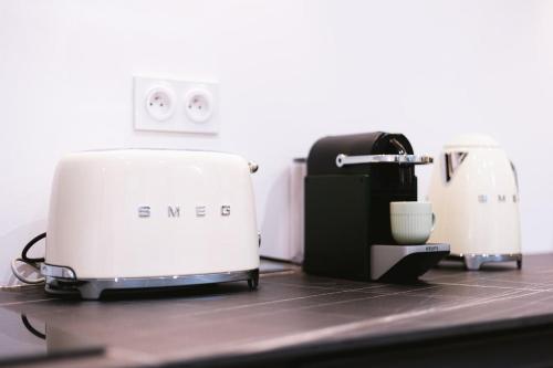 two toasters sitting on top of a counter at Sauna - Massage - Double Shower - Luxe in Romans in Romans-sur-Isère