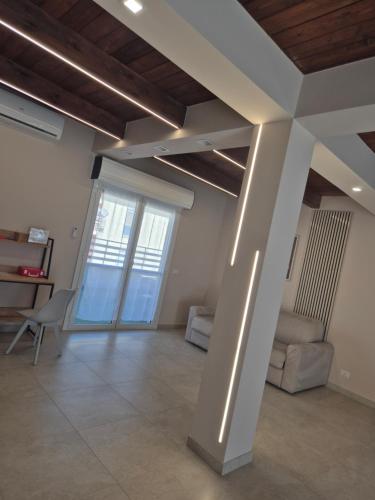 a living room with a couch and a table at Attico Solaris in Reggio Calabria