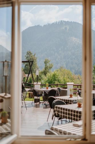 a view from a window of a patio with a mountain view at Hotel Berghaus Rosengarten in Nova Levante