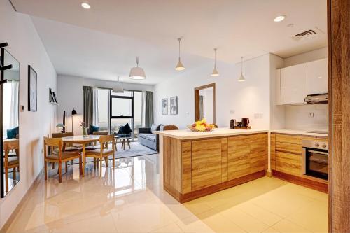 a kitchen and dining room with a table and chairs at Capital Suites Hotel Apartments in Abu Dhabi