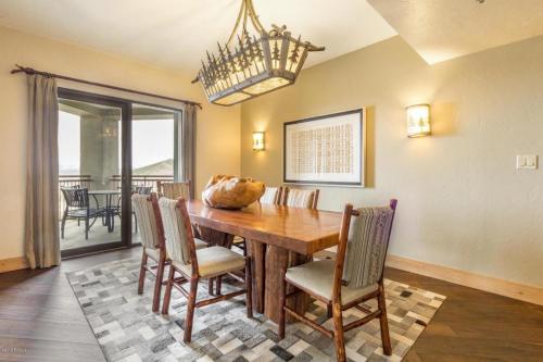 a dining room with a wooden table and chairs at Grand Summit Hotel #702 Penthouse Ski-In, Ski-Out Corner Unit in Park City