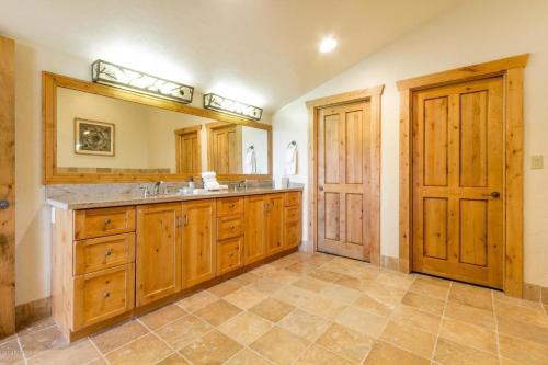 a large bathroom with wooden cabinets and a sink at Grand Summit Hotel #702 Penthouse Ski-In, Ski-Out Corner Unit in Park City