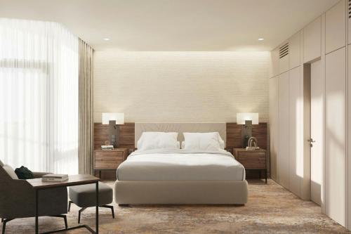 a bedroom with a bed and a desk and a chair at Lisbon Marriott Hotel in Lisbon