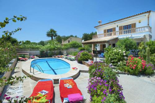 a patio with a swimming pool and a house at Villa Carla by Sealand Villas in Port de Pollensa