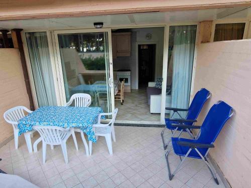 a patio with a table and chairs on a porch at REX LO SCOGLIETTO Nuova Gestione in Punta Ala
