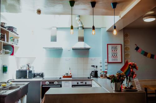 a kitchen with a sink and a stove top oven at Astor Museum Hostel in London