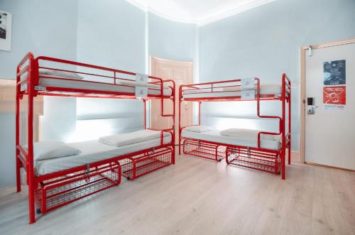 two red bunk beds in a room at Astor Museum Hostel in London