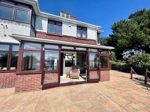 an extension of a house with sliding glass doors at Your Lake side Retreat Sleeps 10-12 Nr Park & Sea in Poole
