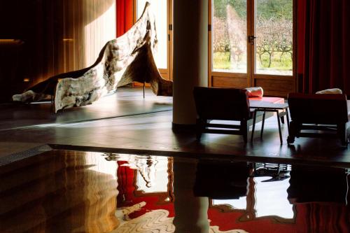 a room with two chairs and a table and a window at Hotel Marqués de Riscal, a Luxury Collection Hotel, Elciego in Elciego