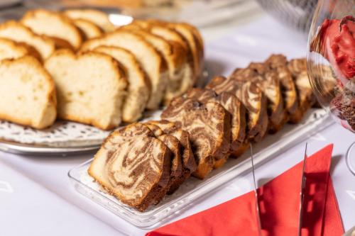 a group of breads and pastries on a table at Aegeon Hotel in Thessaloniki