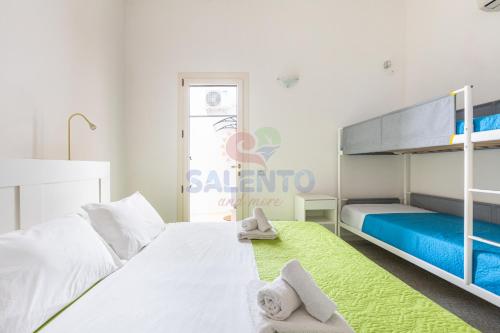 a bedroom with a bed and a bunk bed at Salentoandmore - Casa Nova in Torre Pali 