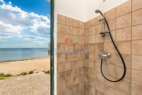 a shower with a view of the beach at Salentoandmore - Casa Nova in Torre Pali 