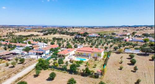 an aerial view of a house with a pool at Pôr-do-sol Villa in São Pedro do Corval