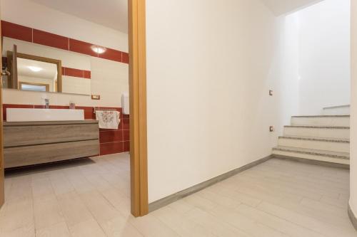 a bathroom with a sink and a mirror at Villino Elisa in Tertenìa
