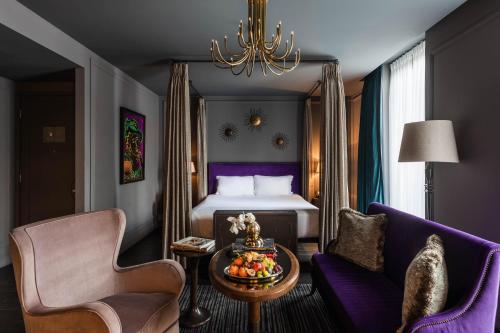 a hotel room with a bed and a table and a chair at The Mandrake in London