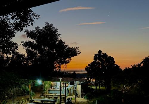 a gas station with a sunset in the background at Baan Plai Laem Homestay at Koh Paluay in Koh Phaluai