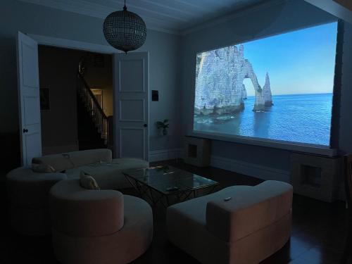 a living room with a large screen with a boat on it at Winter Fun - Spa, Pinball, Billiard and more in Kumeu
